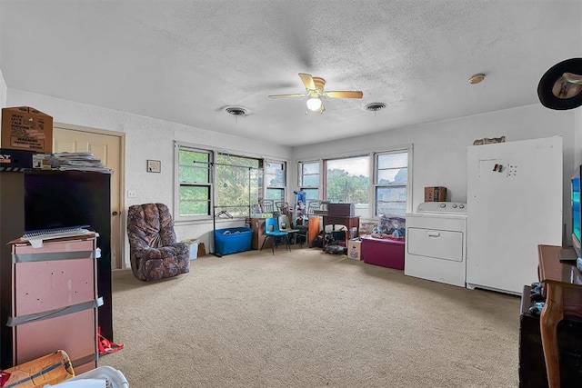 game room featuring washer / dryer, ceiling fan, a textured ceiling, and visible vents