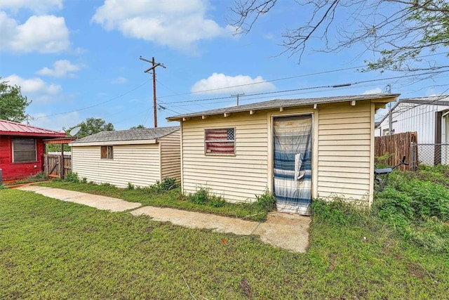 view of outbuilding with fence and an outdoor structure