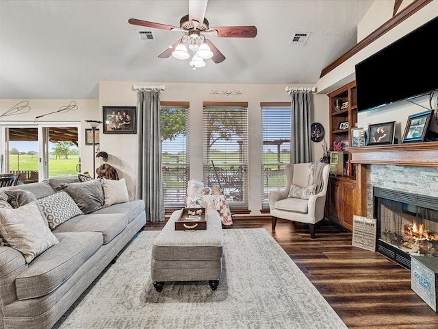 living area with a healthy amount of sunlight, a ceiling fan, and visible vents