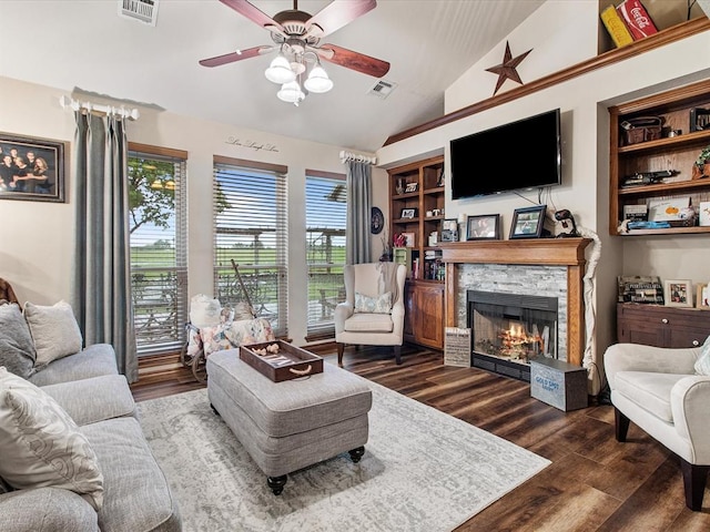 living area with vaulted ceiling, wood finished floors, and visible vents