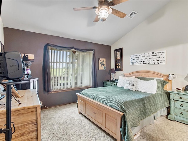 carpeted bedroom featuring visible vents, a ceiling fan, and lofted ceiling