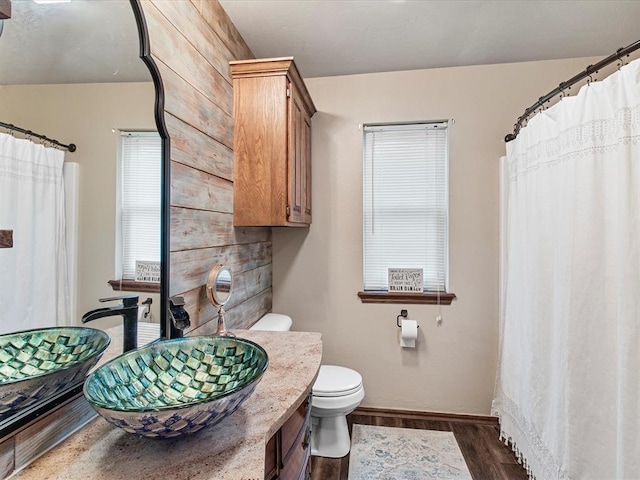 full bath with vanity, baseboards, toilet, and wood finished floors