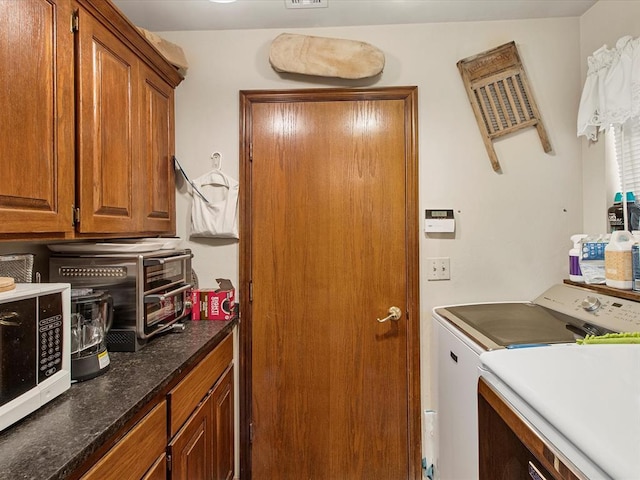 laundry area featuring cabinet space and separate washer and dryer