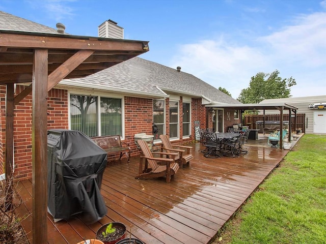 wooden terrace with a grill and outdoor dining space