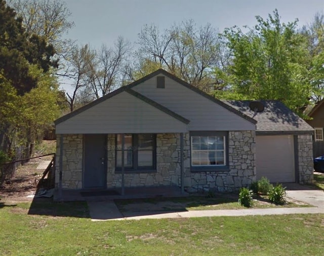 bungalow-style house featuring fence, stone siding, a porch, a front yard, and concrete driveway