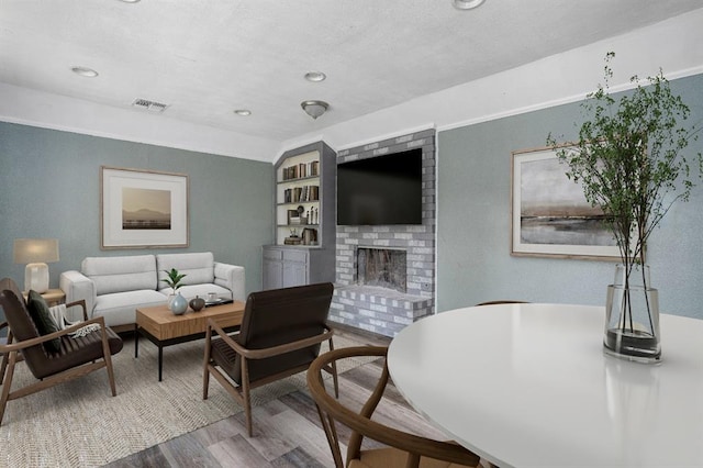 1824 David Ter, Oklahoma City, OK 73141 - living area featuring recessed lighting, a brick fireplace, visible vents, and wood finished floors