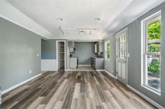 1824 David Ter, Oklahoma City, OK 73141 - unfurnished living room with track lighting, wood finished floors, baseboards, and a sink