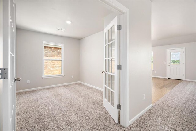 carpeted empty room with baseboards and visible vents