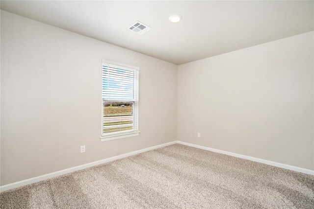 carpeted spare room featuring baseboards, recessed lighting, and visible vents