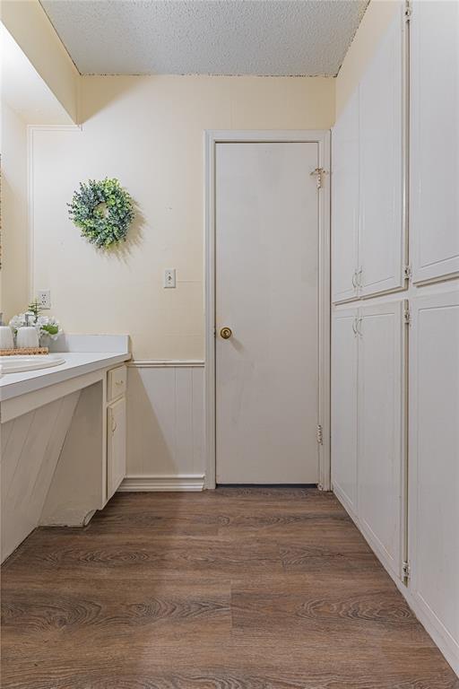 bathroom featuring vanity, a textured ceiling, and wood finished floors