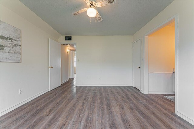 empty room featuring a ceiling fan, a textured ceiling, and wood finished floors