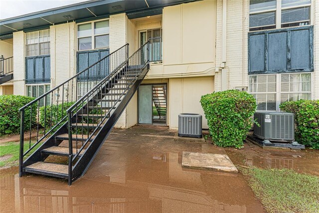 exterior space with central AC unit and stairway