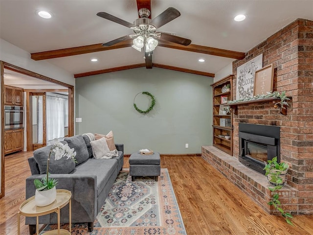 living area with a fireplace, light wood-style floors, a ceiling fan, baseboards, and recessed lighting
