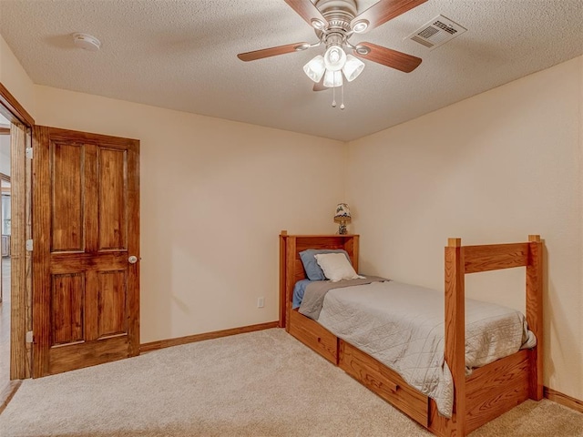 bedroom with carpet flooring, ceiling fan, a textured ceiling, baseboards, and visible vents