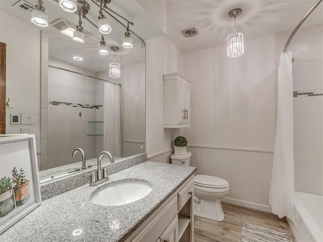 bathroom featuring vanity, wood finished floors, visible vents, and toilet