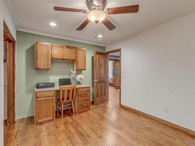 kitchen with a ceiling fan, a textured ceiling, crown molding, light wood-type flooring, and light countertops