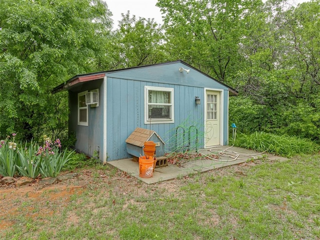 view of outdoor structure featuring a wall mounted air conditioner