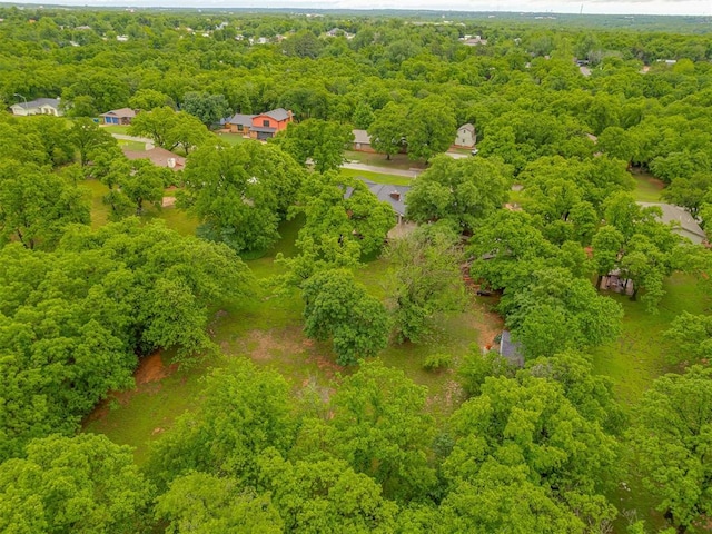 bird's eye view with a wooded view