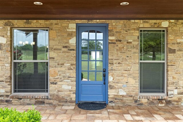 doorway to property featuring stone siding