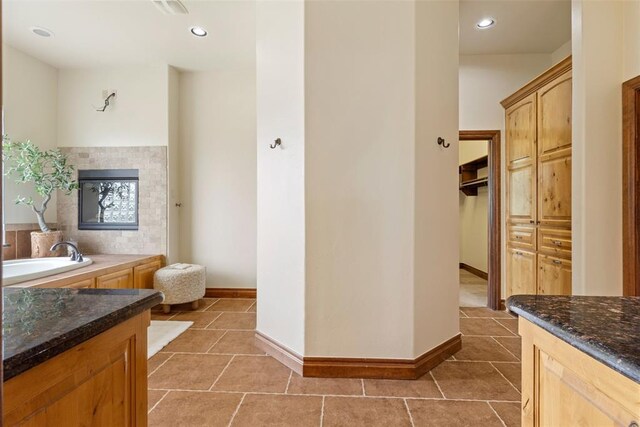bathroom featuring a bathing tub, recessed lighting, baseboards, and tile patterned flooring
