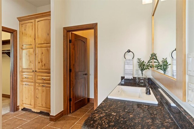 bathroom with a sink and tile patterned flooring