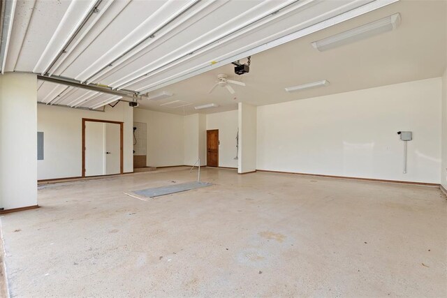 garage with a garage door opener and electric panel