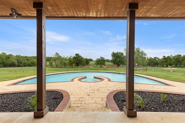 outdoor pool featuring a yard and a patio area