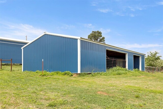 view of pole building with a yard
