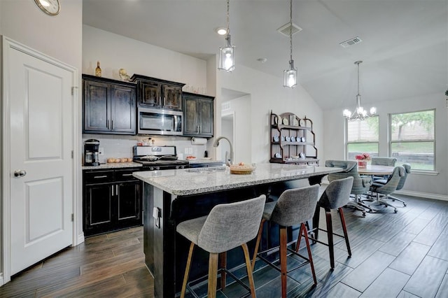 13313 Watson Dr, Piedmont, OK 73078 - kitchen featuring stainless steel appliances, visible vents, a kitchen breakfast bar, and an inviting chandelier