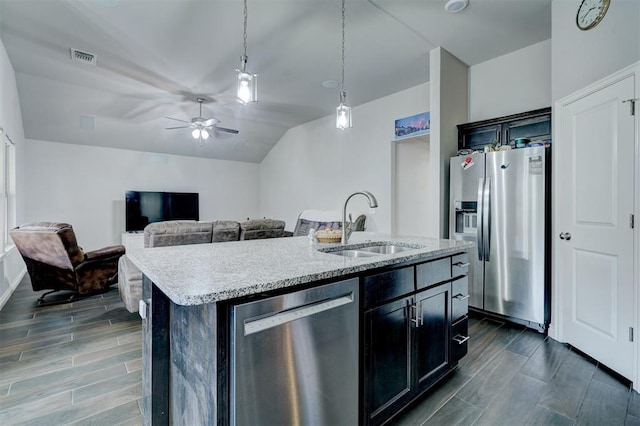 13313 Watson Dr, Piedmont, OK 73078 - kitchen with appliances with stainless steel finishes, a sink, a center island with sink, a ceiling fan, and pendant lighting