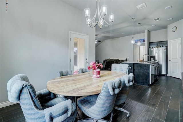 13313 Watson Dr, Piedmont, OK 73078 - dining room featuring visible vents, dark wood finished floors, ceiling fan with notable chandelier, and baseboards