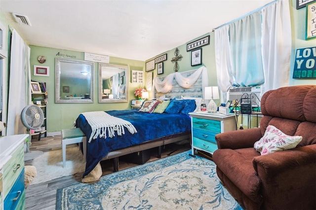 5720 12th Ave NW, Norman, OK 73069 - bedroom featuring wood finished floors and cooling unit