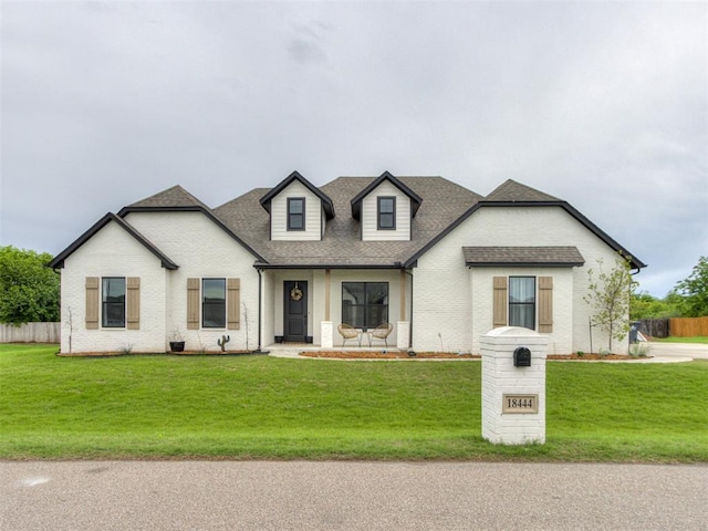 18444 Posse Trl, Norman, OK 73071 - modern inspired farmhouse with a front lawn, roof with shingles, and fence