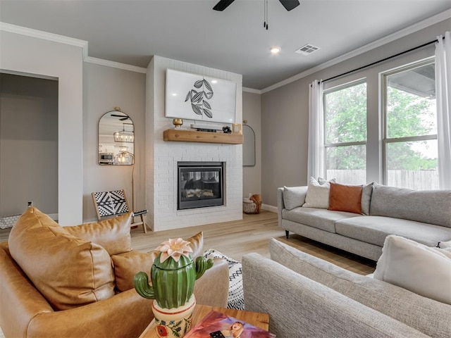 18444 Posse Trl, Norman, OK 73071 - living room with visible vents, ornamental molding, wood finished floors, and a fireplace