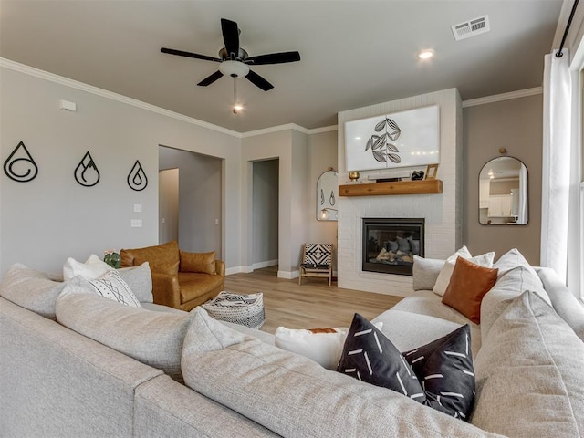 18444 Posse Trl, Norman, OK 73071 - living area featuring visible vents, ornamental molding, wood finished floors, baseboards, and ceiling fan