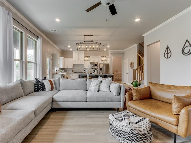 18444 Posse Trl, Norman, OK 73071 - living area with crown molding, visible vents, recessed lighting, light wood-type flooring, and ceiling fan with notable chandelier