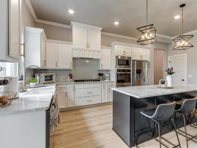 18444 Posse Trl, Norman, OK 73071 - kitchen featuring decorative backsplash, a sink, ornamental molding, stainless steel appliances, and white cabinetry