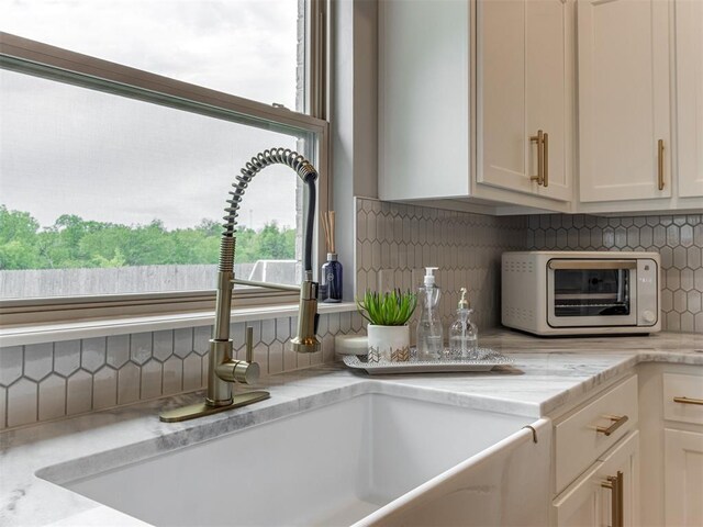 18444 Posse Trl, Norman, OK 73071 - interior details with a sink, white cabinets, backsplash, and a toaster