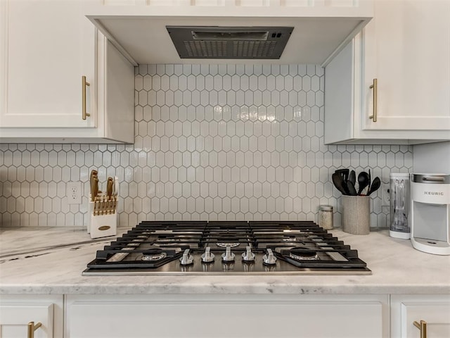 18444 Posse Trl, Norman, OK 73071 - kitchen featuring stainless steel gas cooktop, white cabinetry, exhaust hood, and decorative backsplash