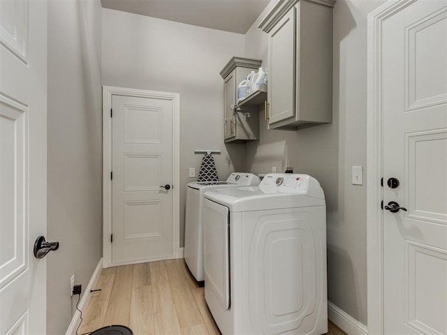 18444 Posse Trl, Norman, OK 73071 - washroom featuring baseboards, cabinet space, independent washer and dryer, and light wood finished floors
