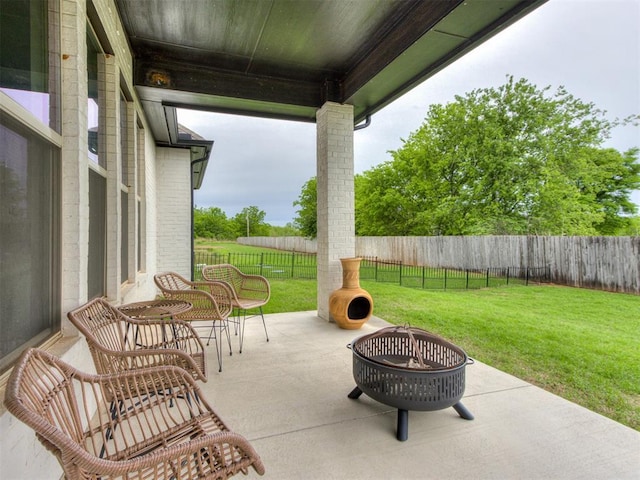 18444 Posse Trl, Norman, OK 73071 - view of patio featuring a fenced backyard and an outdoor fire pit