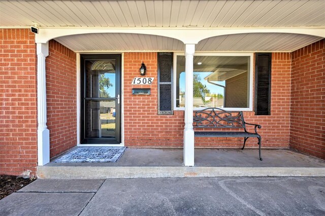 1508 Carlton Way, Oklahoma City, OK 73120 - property entrance featuring a porch and brick siding