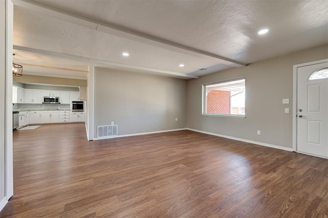 1508 Carlton Way, Oklahoma City, OK 73120 - unfurnished living room with baseboards, visible vents, and dark wood-style floors