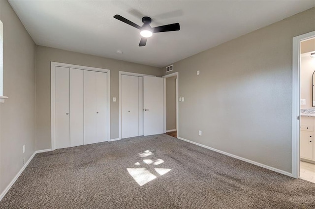 1508 Carlton Way, Oklahoma City, OK 73120 - unfurnished bedroom featuring visible vents, baseboards, two closets, ensuite bathroom, and carpet flooring