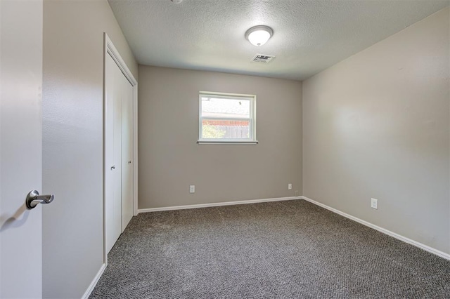 1508 Carlton Way, Oklahoma City, OK 73120 - unfurnished bedroom with carpet flooring, a textured ceiling, baseboards, visible vents, and a closet