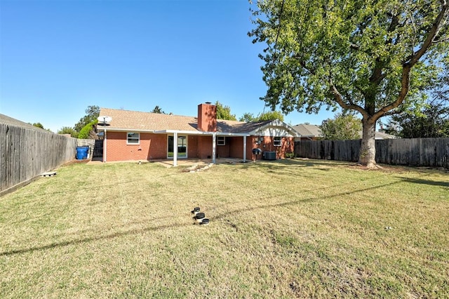 1508 Carlton Way, Oklahoma City, OK 73120 - rear view of property with a lawn, brick siding, a chimney, and a fenced backyard