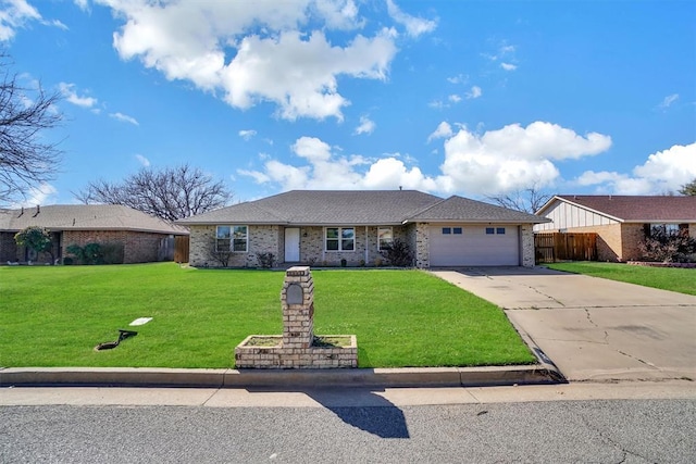 ranch-style house with fence, an attached garage, a front lawn, brick siding, and concrete driveway