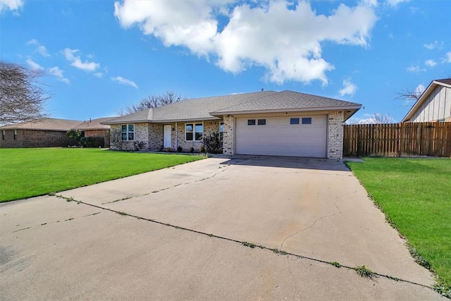ranch-style house featuring a front lawn, fence, brick siding, concrete driveway, and an attached garage