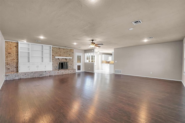 unfurnished living room with baseboards, a ceiling fan, dark wood-style floors, and a textured ceiling