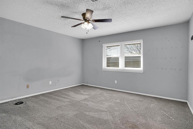 spare room with carpet floors, a textured ceiling, baseboards, and ceiling fan